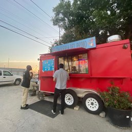 two people ordering food from a food truck