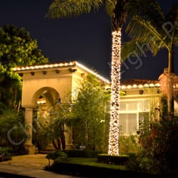 Clear C9 Incandescent to outline roofline and two large Palm trees wrapped with mini incandescent lights with 3" spacing