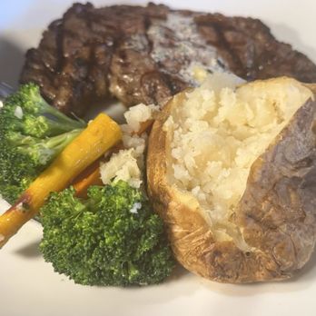 Trancas Steakhouse - Grilled Rib Eye Steak (14oz. cut)w/baked potato and mixed vegetable blend - Steakhouses Near Me - Napa, California Trancas Steakhouse - Grilled Rib Eye Steak (14oz. cut)w/baked potato and mixed vegetable blend - Steakhouses Near Me - Napa, California