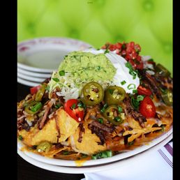 a plate of nachos on a table a plate of nachos on a table