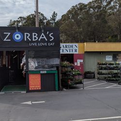 Zorbas Gyros - The full outside. It's basically a structure built around a food truck / trailer at the far left end of the goodmans parking lot.