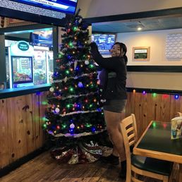 Deli is decorating the Christmas tree. She is one of their Hostesses. Very sweet young lady!