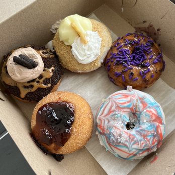 Purple Glaze Donuts - Purple Glaze, Fireworks (vanilla glaze with pop rocks), Sinfully Jelly, Mudslide ( chocolate icing and caramel drizzle), Banana Crème - Donuts Near Me - Asbury Park, New Jersey