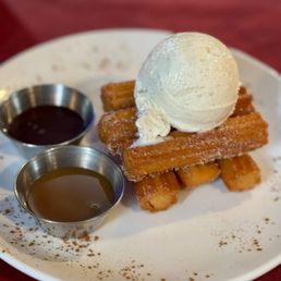 Churros with caramel, chocolate sauce, and vanilla ice cream
