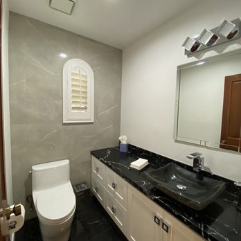 Romano Builders - a bathroom with a toilet and sink - General Contractors Near Me - Agoura Hills, California Romano Builders - a bathroom with a toilet and sink - General Contractors Near Me - Agoura Hills, California