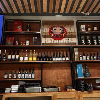 Yujo Nori - a wooden bar with shelves of wine bottles - Japanese Near Me - Carrollton, Texas