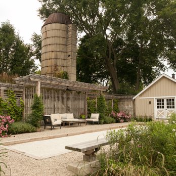 Greenhaven Landscapes - a garden with a bench and a silo in the background - Landscaping Near Me - Zion, Illinois