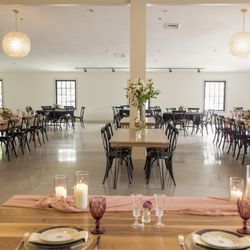 South Haven Creations - Wedding reception room at South Haven Creations. Solid handcrafted walnut tables come with the venue.