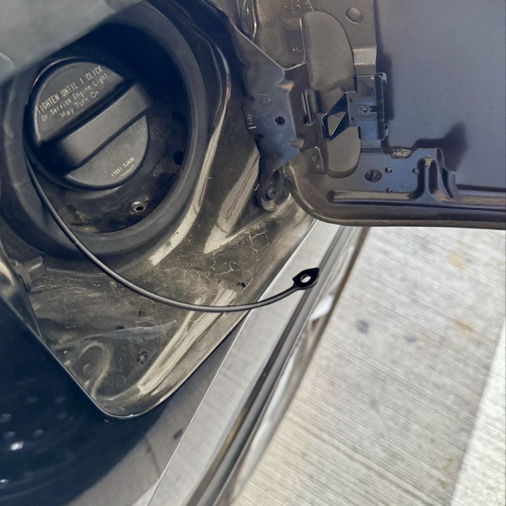 Factory designed tassel left detached after the assistant manager "YANKED" the gas cap off the gas lid. Factory designed tassel left detached after the assistant manager "YANKED" the gas cap off the gas lid.