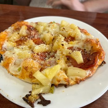 Deano's Pizza - a slice of pizza on a plate - Pizza Near Me - Lafayette, Louisiana