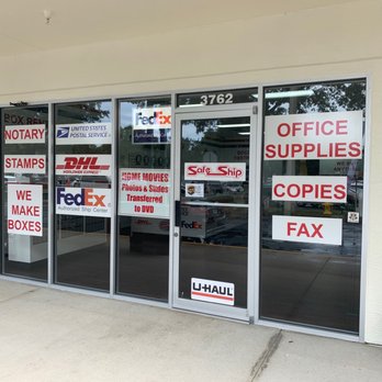 Safe Ship - USPS, FedEx, DHL, Copies, Shipping supplies, Boxes, Notary, Fax, Scan to email, Notary, Uhaul. - Glass storefront with signs advertising shipping, notary, copies, and fax services, including FedEx, DHL, USPS, and U-Haul. - Shipping Centers Near Me - Ormond Beach, Florida