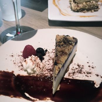 Blade 1936 - Lemon Blueberry Crumb Ricotta Cheesecake and a glass of Pinot Noir. - Pizza Near Me - Oceanside, California Blade 1936 - Lemon Blueberry Crumb Ricotta Cheesecake and a glass of Pinot Noir. - Pizza Near Me - Oceanside, California