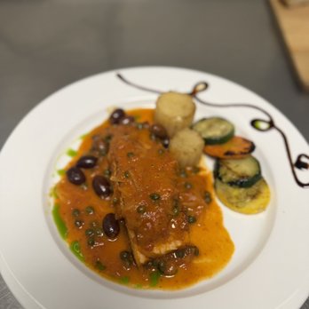 Il Gusto - Fresh fillet of wild salmon with caramelized onions, black olives, and capers in a delicate marinara broth. - Italian Near Me - Philadelphia, Pennsylvania Il Gusto - Fresh fillet of wild salmon with caramelized onions, black olives, and capers in a delicate marinara broth. - Italian Near Me - Philadelphia, Pennsylvania