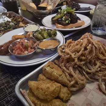 Lucille's Smokehouse Bar-B-Que - From left to right: Nachos, a plate to share things with sauces, nacho toppings, and half of the jalapeño sausage, and an appetizer platter. - Barbeque Near Me - Rocklin, California Lucille's Smokehouse Bar-B-Que - From left to right: Nachos, a plate to share things with sauces, nacho toppings, and half of the jalapeño sausage, and an appetizer platter. - Barbeque Near Me - Rocklin, California
