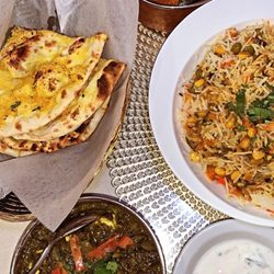 Flavor of India North & South Cuisine - Garlic Naan, veggie rice, cheese cube and spinach, chicken and potato