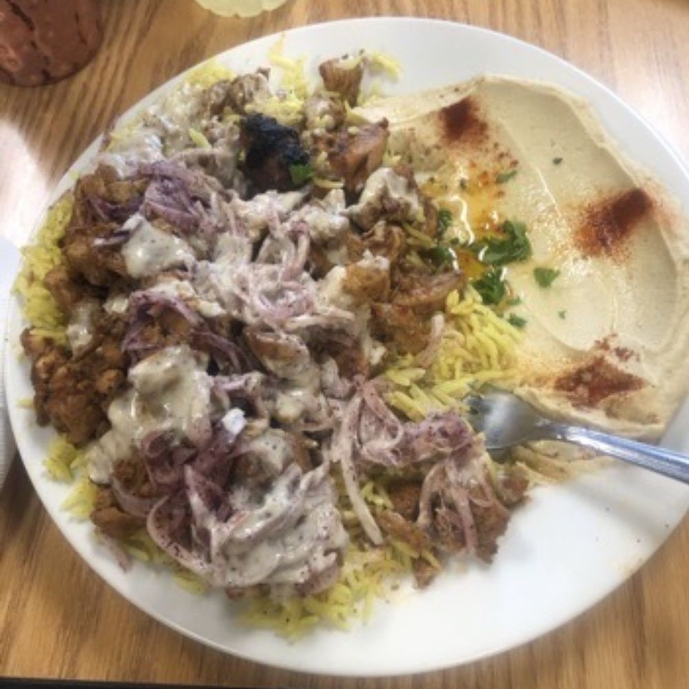 (Chicken Shawarma Plate) Chicken Shawarma Meat over a bed of rice and with the Side of Hummus extra onions
