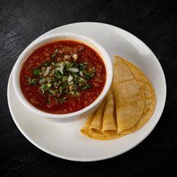 Fuego Cravings - A hearty 32oz serving of tender birria in rich consommé, served with four warm corn tortillas.