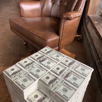 Rize kitchen -  stack of $ 100 bills on a coffee table - Breakfast & Brunch Near Me