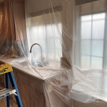Simpex Repipe & Plumbing - Plastic sheeting covers a kitchen sink and window, indicating ongoing renovation or plumbing work in a residential space. - Plumbing Near Me - Irvine, California