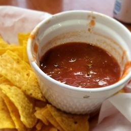a bowl of salsa and chips