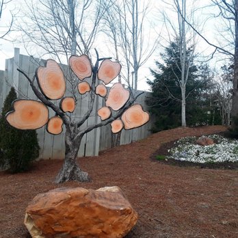 Dollywood - Dollywood's unofficial logo of a butterfly, seen here in slices of a tree! The landscaping at the park is beautiful. - Amusement Parks Near Me - Pigeon Forge, Tennessee Dollywood - Dollywood's unofficial logo of a butterfly, seen here in slices of a tree! The landscaping at the park is beautiful. - Amusement Parks Near Me - Pigeon Forge, Tennessee