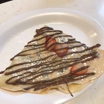 Nutella Cafe - Strawberry crepe with Nutella drizzle. Why my daughter skipped whipped cream as an add-on is a mystery. - Desserts Near Me - Chicago, Illinois Nutella Cafe - Strawberry crepe with Nutella drizzle. Why my daughter skipped whipped cream as an add-on is a mystery. - Desserts Near Me - Chicago, Illinois