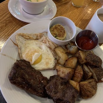 Irregardless Cafe - Steak and eggs, cheesy grits, 1 crab cake - New American Near Me - Raleigh, North Carolina