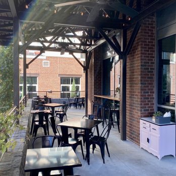 La Chiquiada - One side of the covered patio and plentiful seating. There is another side to this wraparound patio and more pretty landscaping - Mexican Near Me - Decatur, Georgia