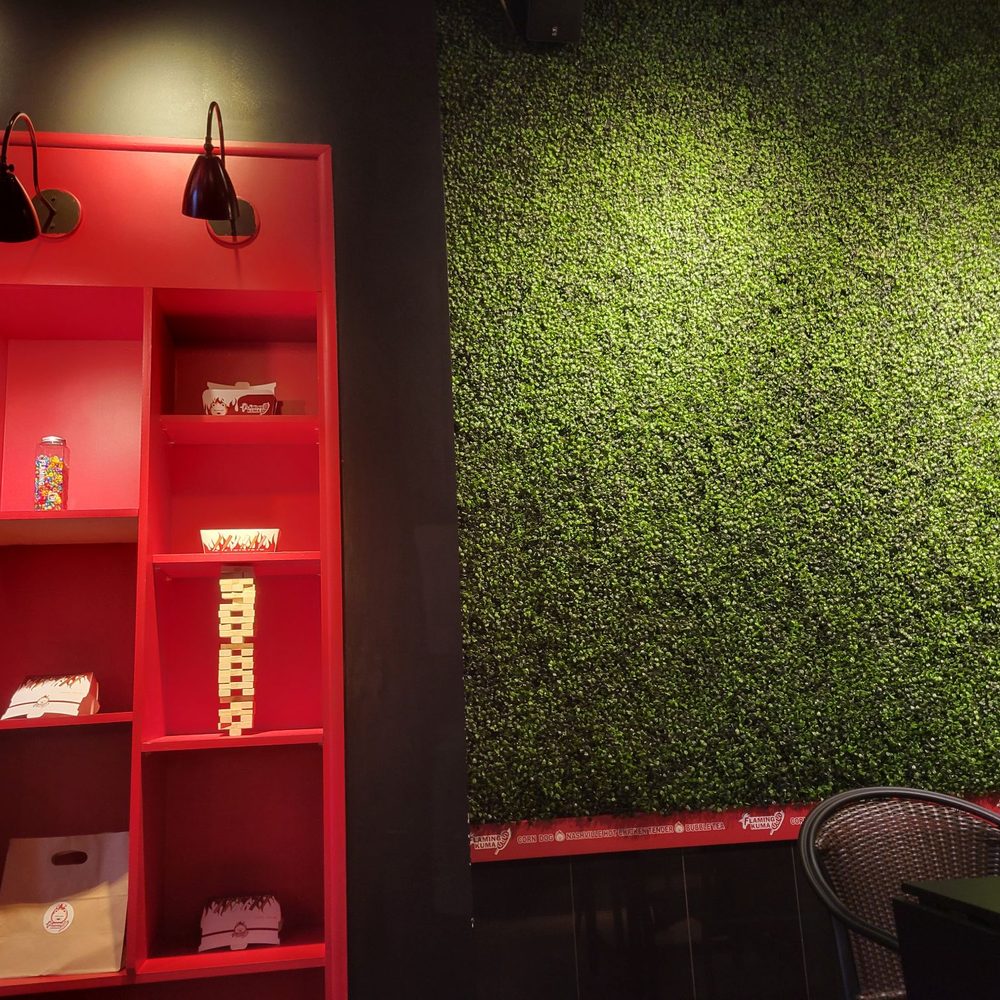 Flaming Kuma - a green wall and red shelves - Hot Dogs Near Me - West Lafayette, Indiana Flaming Kuma - a green wall and red shelves - Hot Dogs Near Me - West Lafayette, Indiana