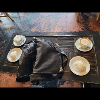Caffe Zingaro - Two deep, cozy leather chairs and a coffee table large enough to fit our giant messenger bags. Cool acid washed concrete floor is a plus - Desserts Near Me - Seattle, Washington