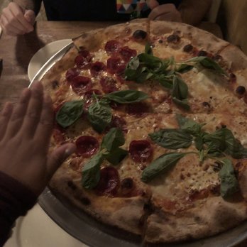 Lucali - Half BEEF Pepperoni and half cheese! Also my hand to show you how big this pizza is. - Pizza Near Me - Brooklyn, New York