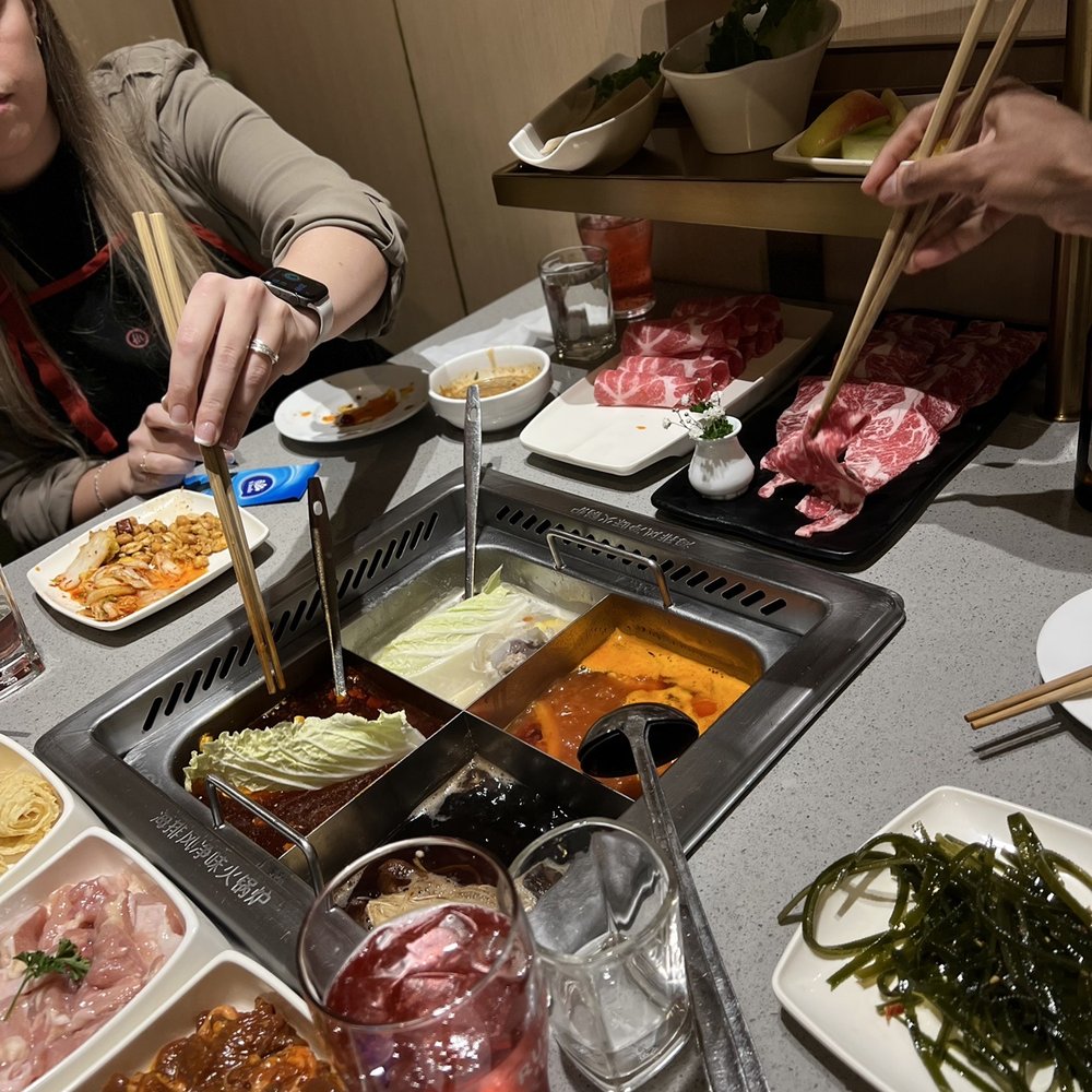 Haidilao Hotpot - a woman eating at a restaurant - Hot Pot Near Me - Vancouver, British Columbia Haidilao Hotpot - a woman eating at a restaurant - Hot Pot Near Me - Vancouver, British Columbia