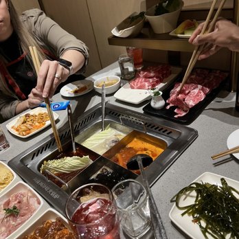 Haidilao Hotpot - a woman eating at a restaurant - Hot Pot Near Me - Vancouver, British Columbia Haidilao Hotpot - a woman eating at a restaurant - Hot Pot Near Me - Vancouver, British Columbia