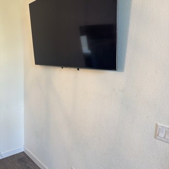 The Floating TV - One of four TVs floated with the hidden wires, going through the wall to the outlet - Home Theatre Installation Near Me