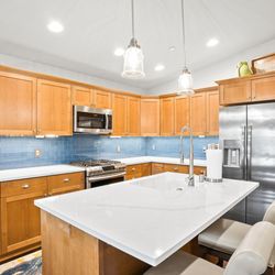 Harbor Kitchen and Bath + Countertops - Lx Viatera quartz countertops, with Twilight Blue tile backsplash.
