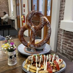 Prost Beer Hall - Pretzel and bratwurst on fries.