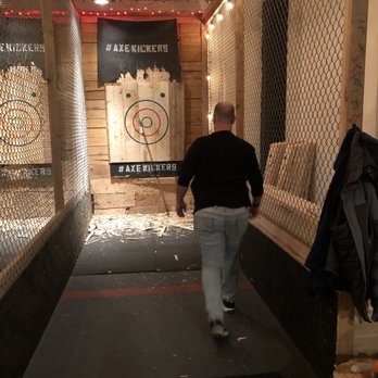 Axe Kickers - Hubby getting his axe that he just threw in our single practice lane - Axe Throwing Near Me - Seattle, Washington