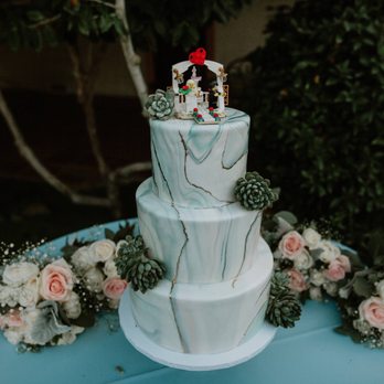 Hidalgo Flowers - Trimmed succulents on cake and bridesmaids bouquets laid behind. - Florists Near Me - Vista, California