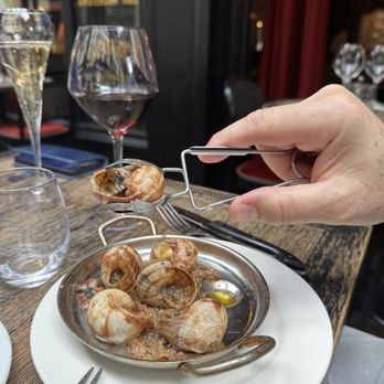 L'Escargot - The most specific dining implement ever-snail tongs, immobilizing a tasty snail - French Near Me - Paris, 75
