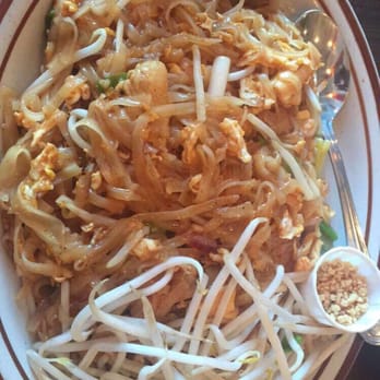 Ubon Thai Kitchen - This is a chicken pad thai with lemon, and chopped peanuts on the side with a piece of fried curry wonton - Thai Near Me - Torrance, California