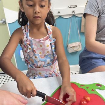 Foodie Kids - Cutting tomatoes for her frittata - Cooking Classes Near Me - Austin, Texas Foodie Kids - Cutting tomatoes for her frittata - Cooking Classes Near Me - Austin, Texas