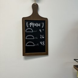 Pricing is on a small board on the right side wall Pricing is on a small board on the right side wall