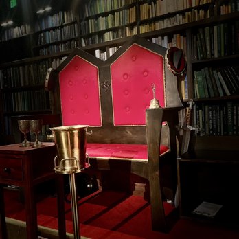 Drunk Shakespeare - a red bench in a library - Performing Arts Near Me - New York, New York Drunk Shakespeare - a red bench in a library - Performing Arts Near Me - New York, New York