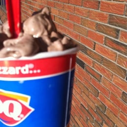 a hand holding a cup of ice cream