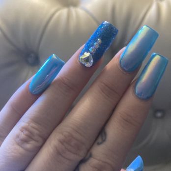 Nuluk Nail Design - Turquoise gel with unicorn powder on top of acrylic nails and sparkle gel nail with rainbow clear, rhinestone heart design. - Nail Salons Near Me - Riverside, California