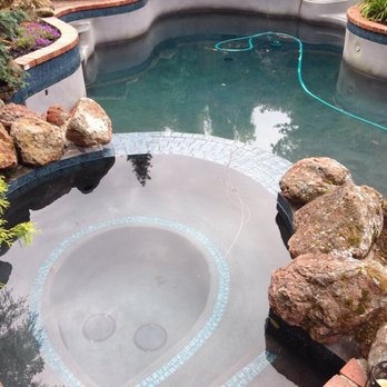 Mathis Pools - a pool surrounded by rocks - Pool Cleaners Near Me Mathis Pools - a pool surrounded by rocks - Pool Cleaners Near Me