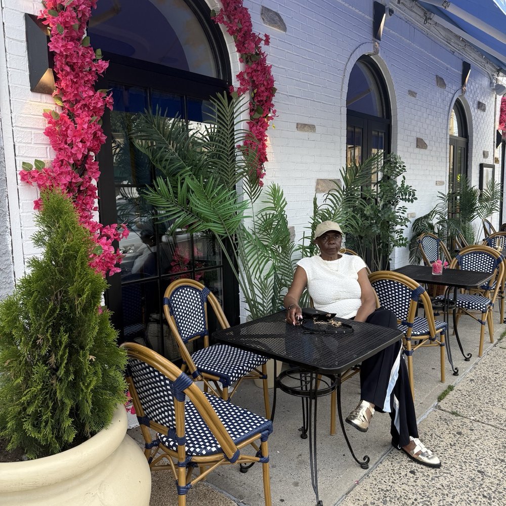 Ilios Taverna - Outside with red poppies. There is outside dining - Bars Near Me - The Bronx, New York