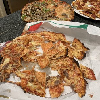 Pierri Pizza - This is the pizza we received. Is this place actually a joke??? What complete WASTE of money. - A pizza with cheese, sausage, and pepperoni has been partially eaten and is on a pizza box on a countertop. - Pizza Near Me - Appleton, Wisconsin