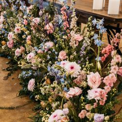 Sweetwater a Flower Market - Flower arrangements in front of the couple's table in the reception hall.