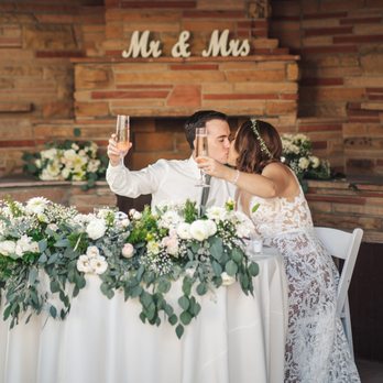 Bella Blooms - After the ceremony, Melanie moved the big floral piece above the archway to the sweetheart table and cut some of it to be behind us as well. - Florists Near Me - Anaheim, California